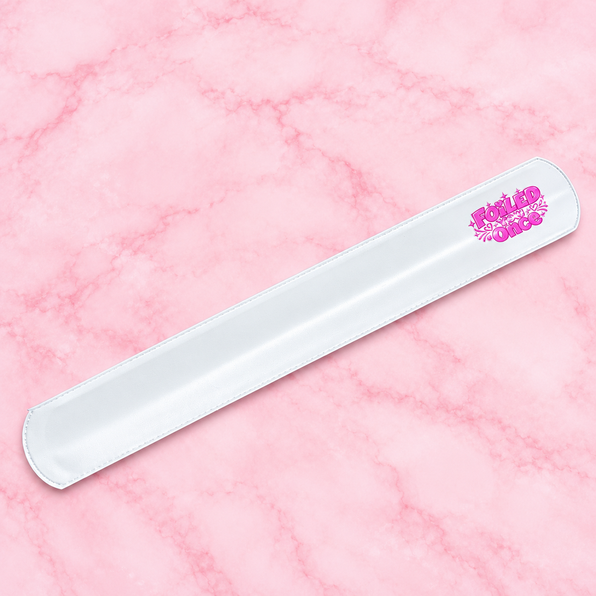 White Foiled You Once branded snap band on a pink marble background