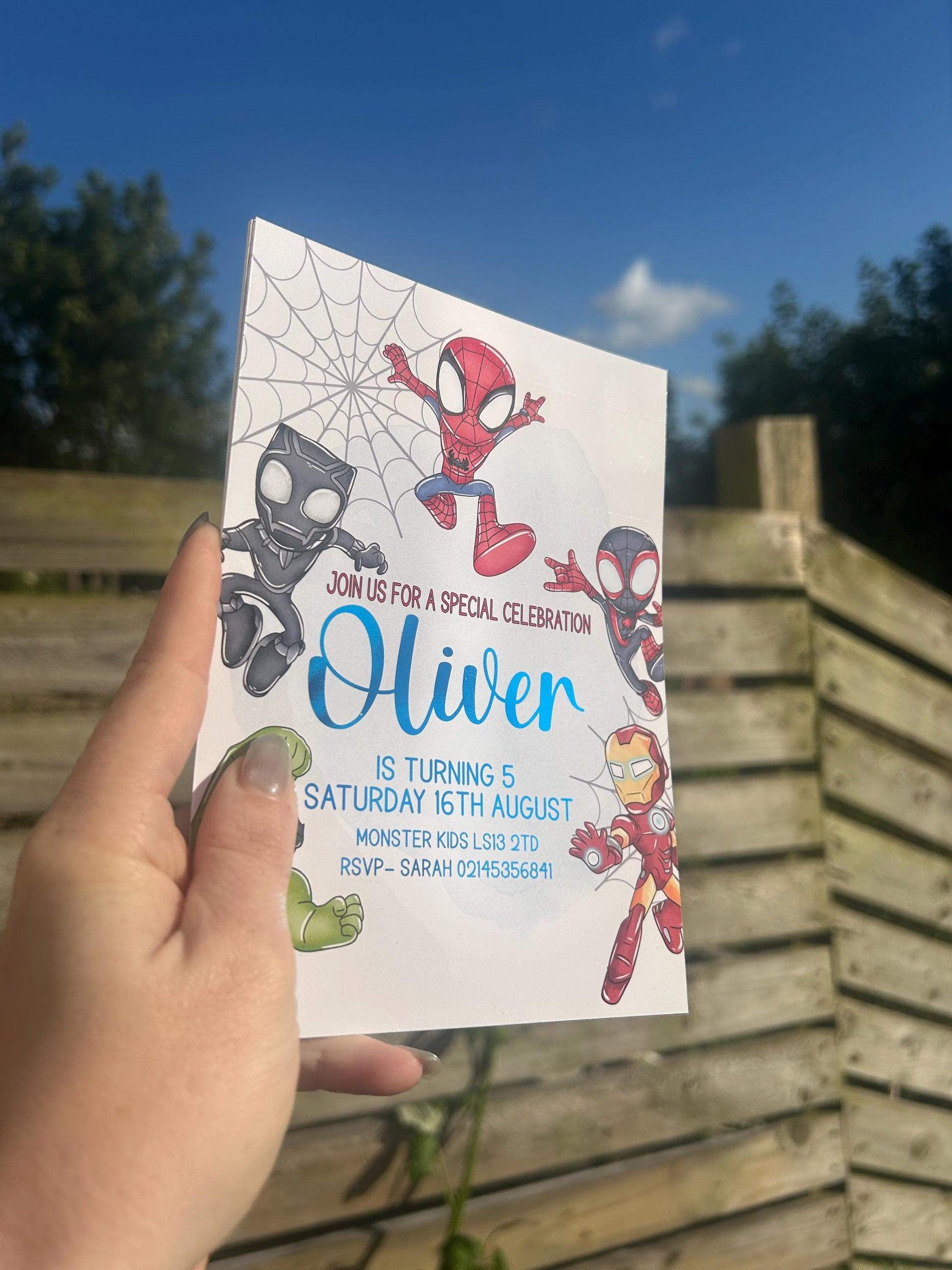 Close up of personalised superhero birthday invite on glossy card