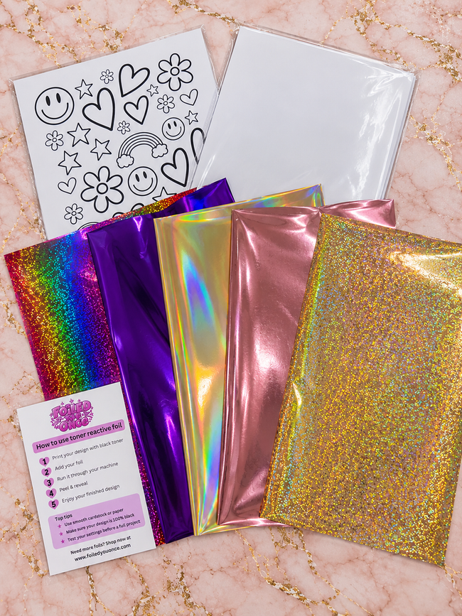 Five A4 foil sheets from the starter kit on blush marble